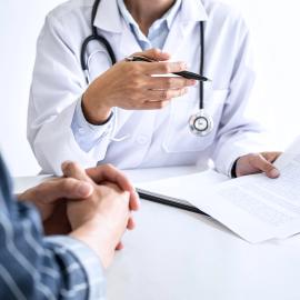 Doctor sitting with patient